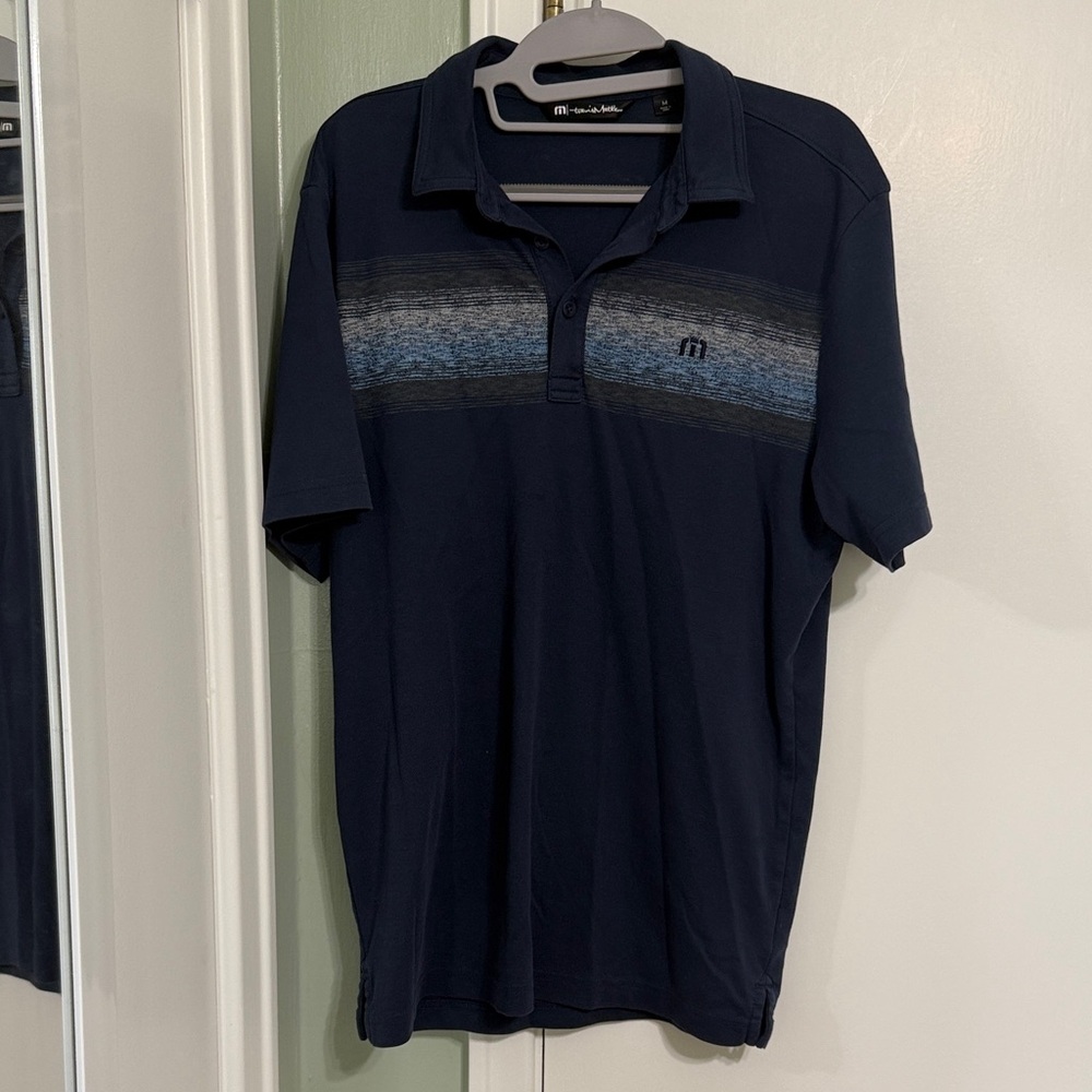 Travis Mathew Navy Polo with Heathered Blue Chest Stripe